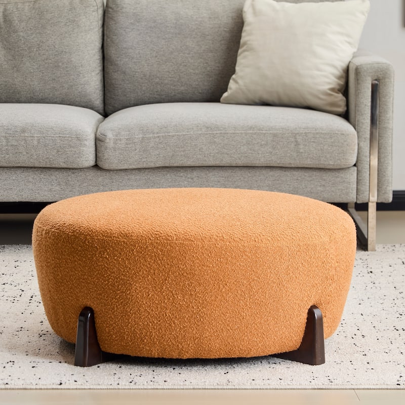 Modish Round Ottoman: Boucle Top with Splayed Rubber Wood Legs, Pumpkin Orange