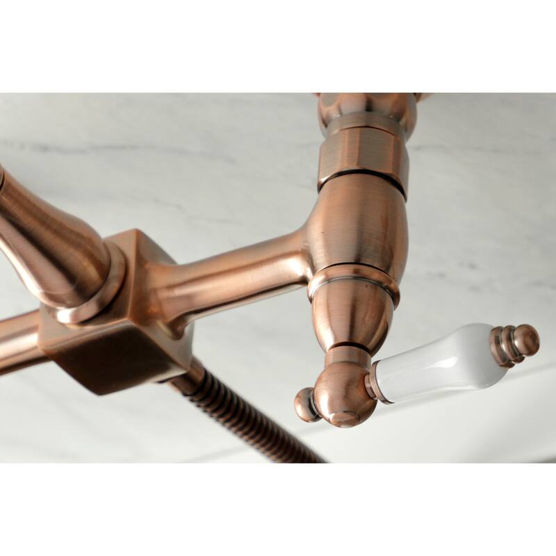 Kingston Brass Heritage Wall Mount Bridge Kitchen Faucet with Brass Sprayer