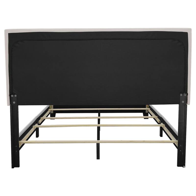 Elegant Ivory Upholstered Bed with Chrome Nailhead Trim and Black Wooden Legs