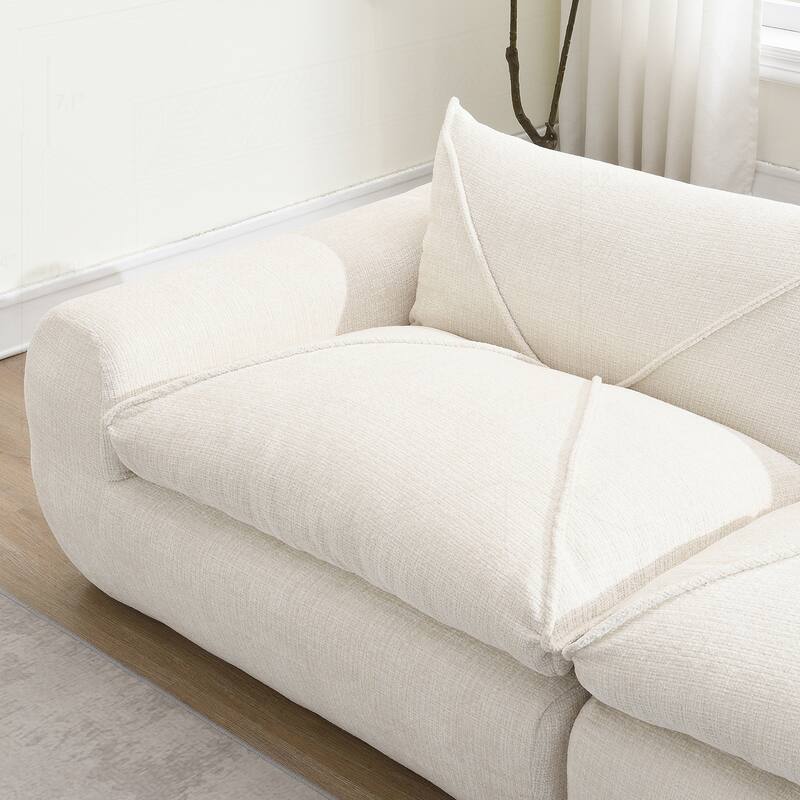 Versatile Compressed Sofa with Integrated Cushions and Movable Ottoman
