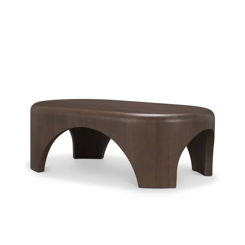 The Shima Coffee Table is a smooth, dark matte brown oval coffee table with curved edges and arched cut out legs.