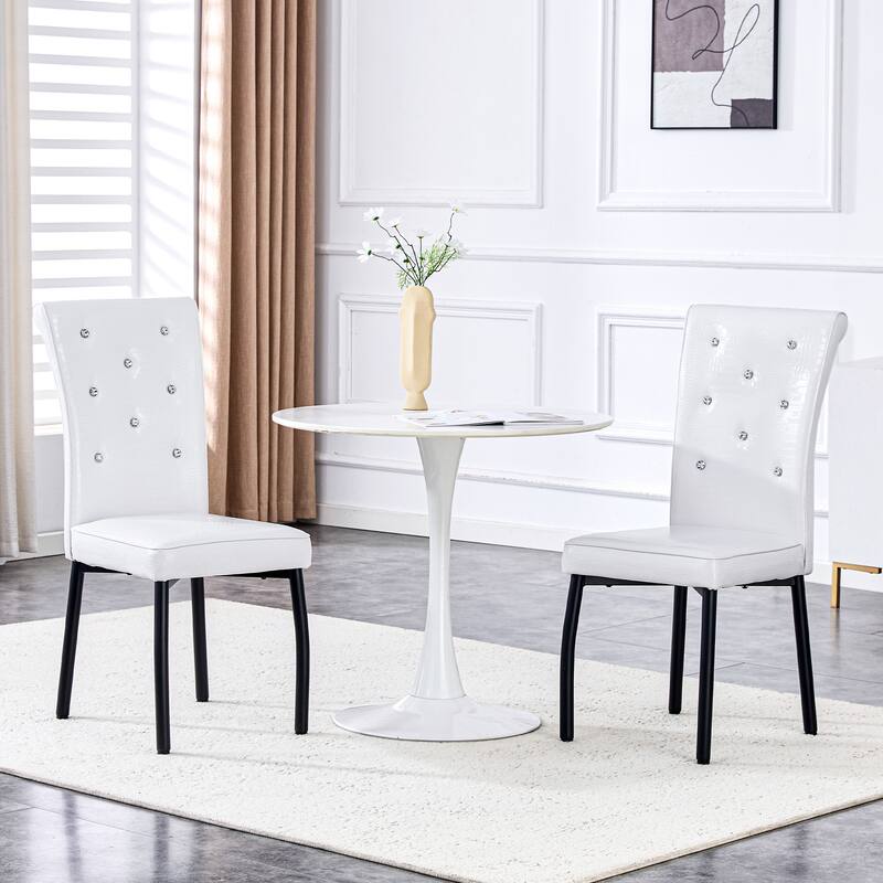 A set of 4 white and black vintage crocodile leather cushioned dining chairs, featuring crystal clasp design and leather