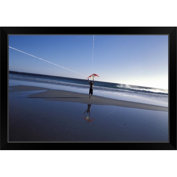"Boy flying kite at beach" Black Framed Print