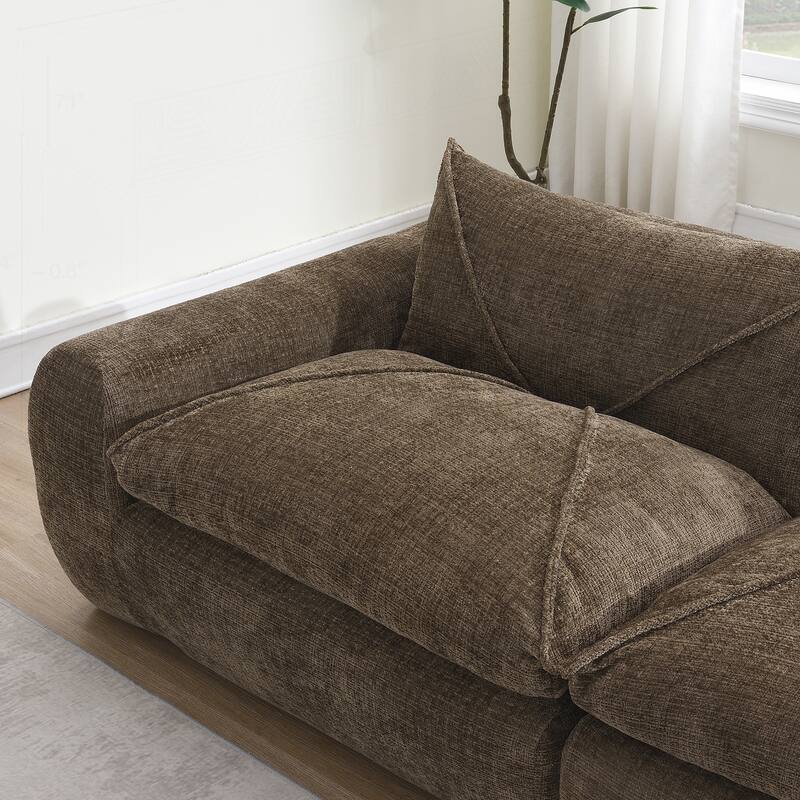 Versatile Compressed Sofa with Integrated Cushions and Movable Ottoman