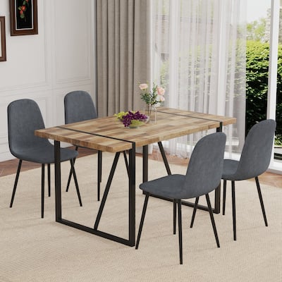 A Minimalist Retro Rectangular Dining Table And Black Metal Legs, Paired With Dark Gray Linen Fabric Chairs.