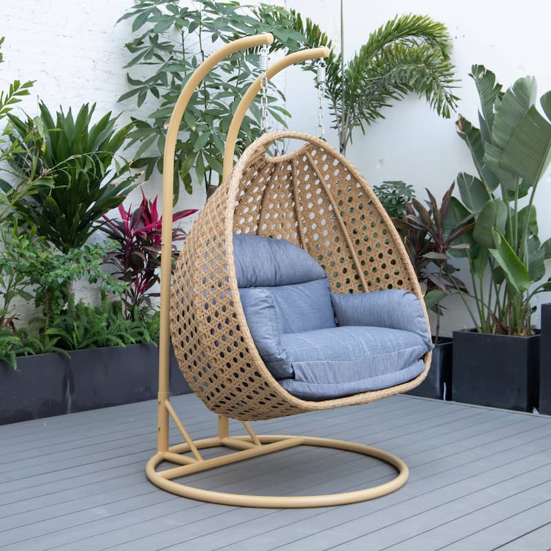 LeisureMod Mendoza 2-Person Hanging Egg Swing Chair - Handcrafted Light Brown Wicker, Patio Hammock Lounger with Cushions - 53"