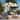 California Umbrella 8.5' Pagoda Series Patio Umbrella White Aluminum Pole Push Lift Sunbrella Natural and Pacific Blue