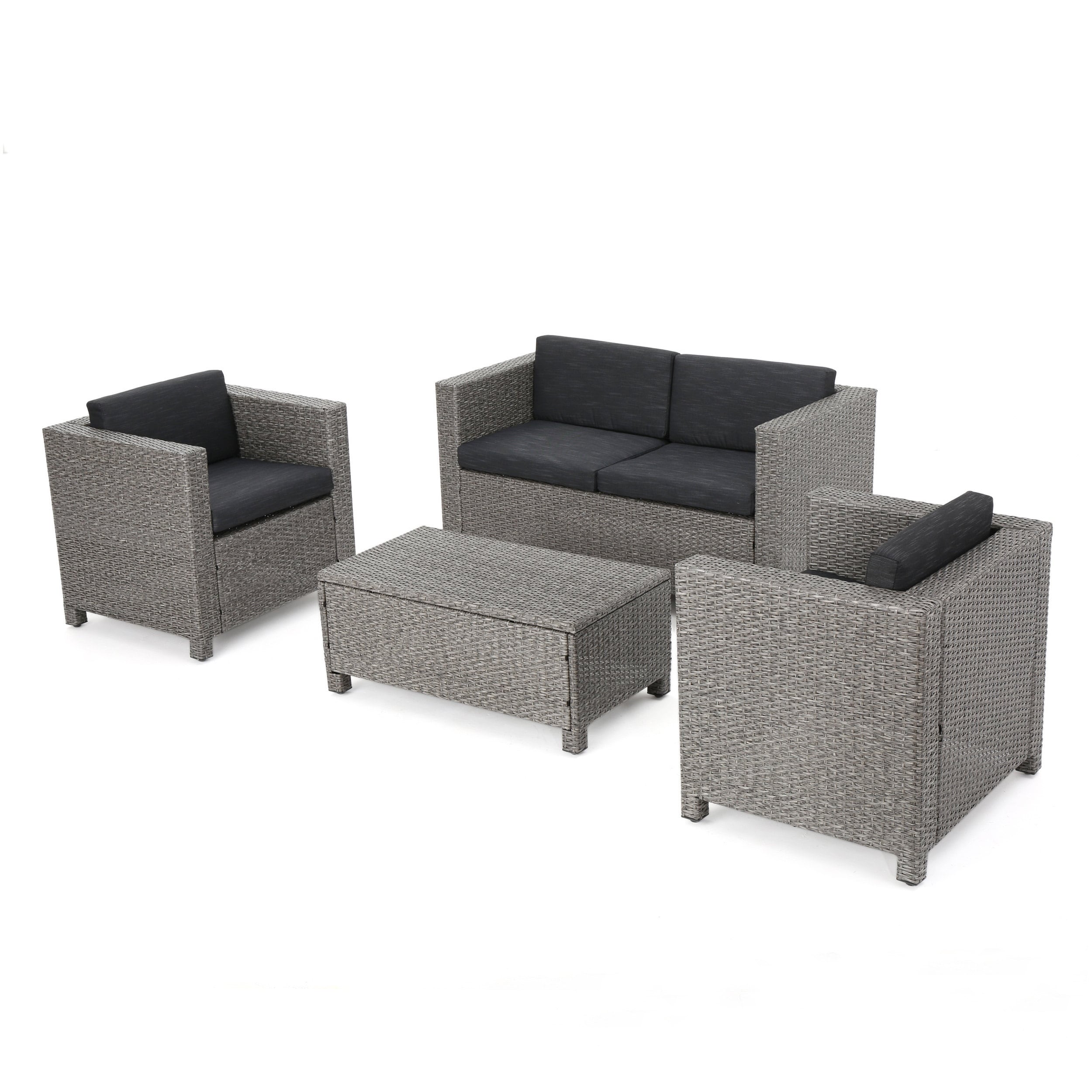 Gray wicker outdoor conversation set with dark cushions including two armchairs, a loveseat, and a coffee table