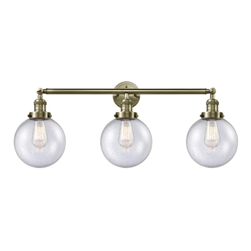Innovations Lighting Beacon 3 Light 32" Wide Bathroom Vanity Light - Antique Brass / Seedy