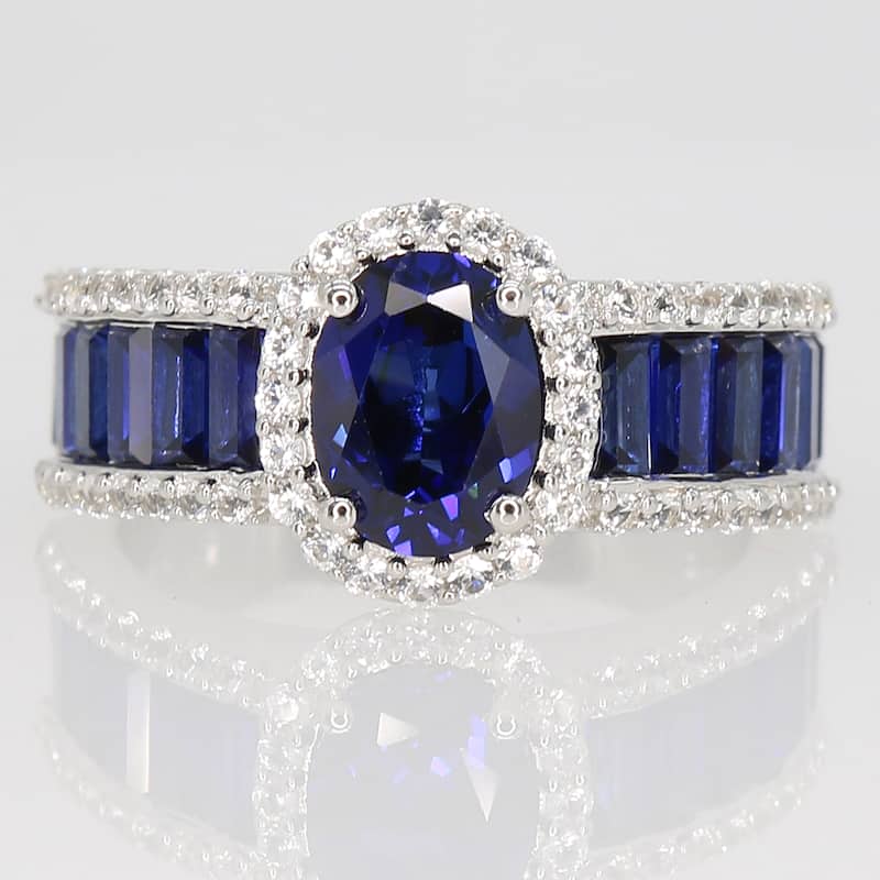 Oval & Baguette-cut Created Blue and White Sapphire Halo Engagement Ring in Sterling Silver by Miadora
