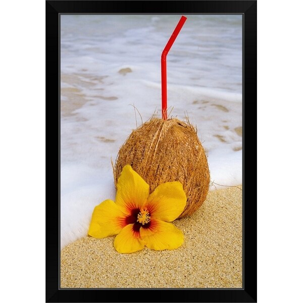 "A coconut drink with straw sticking out and flowers on a tropical beach." Black Framed Print