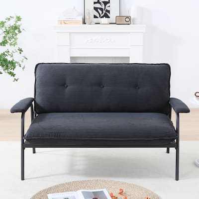 The 53-inch black sofa offers a spacious layout in the small apartment