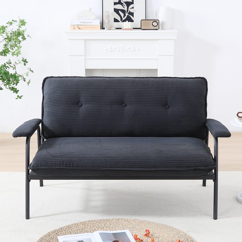 The 53-inch black sofa offers a spacious layout in the small apartment