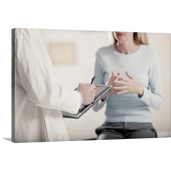 "Doctor holding tablet PC talking to patient" Canvas Wall Art