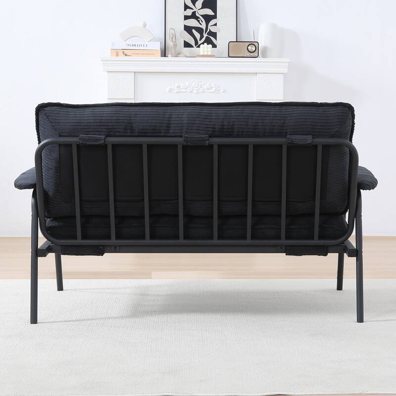 The 53-inch black sofa offers a spacious layout in the small apartment