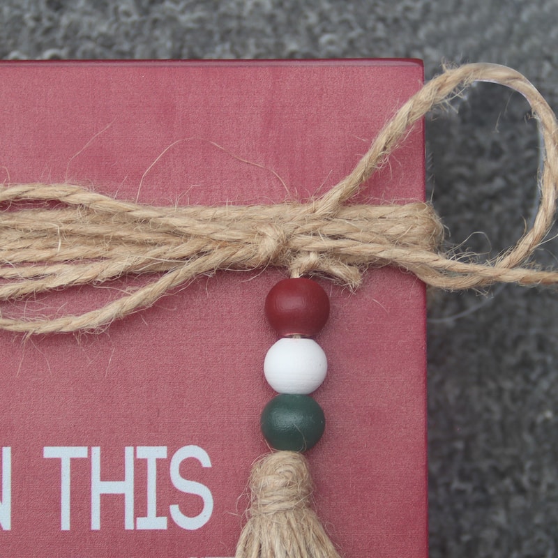 In This Home We Believe Wood Faux Books Decorative Sign with Twine and Beads
