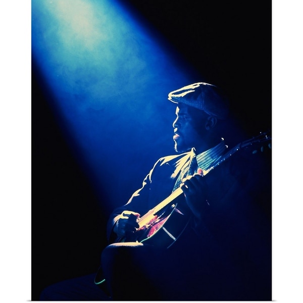 "Guitar player performing in club with spotlight" Poster Print