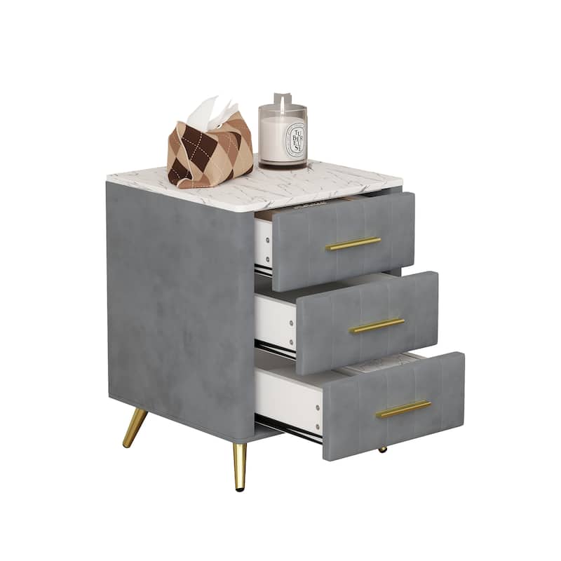 Upholstered Wooden Nightstand Featuring Three Drawers With Metal Legs And Handles.