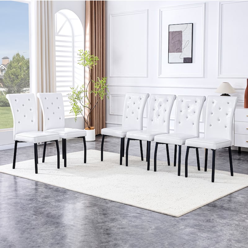 A set of 4 white and black vintage crocodile leather cushioned dining chairs, featuring crystal clasp design and leather