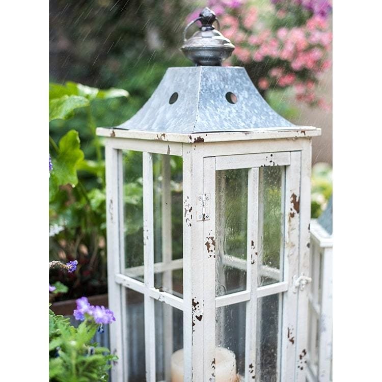 https://ak1.ostkcdn.com/images/products/is/images/direct/d949eb351b24e95a13ee30c488076d8cef7f9c05/RusticReach-Lantern-House-Candle-Holder-in-White.jpg