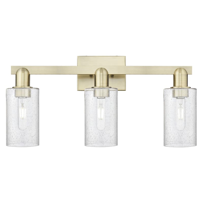 Innovations Lighting 716-3W-11-23 Clymer Vanity Clymer 3 Light 23" - Antique Brass / Seedy