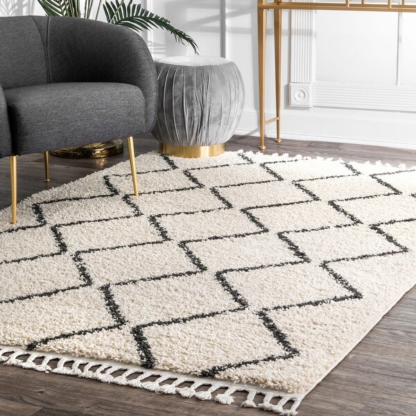 The Curated Nomad Philo Off-white Moroccan Trellis Plush Tassel Shag Area Rug. Opens flyout.