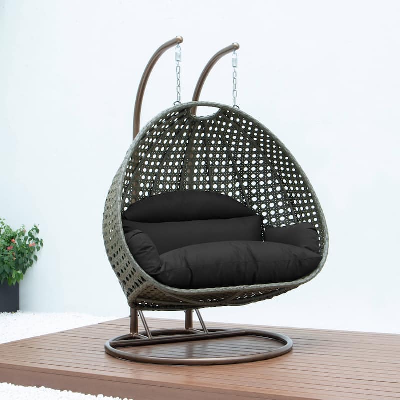 LeisureMod 2-Person Hanging Egg Swing Chair with Metal Stand - Handcrafted Beige Wicker, Patio Hammock Lounger with Cushions