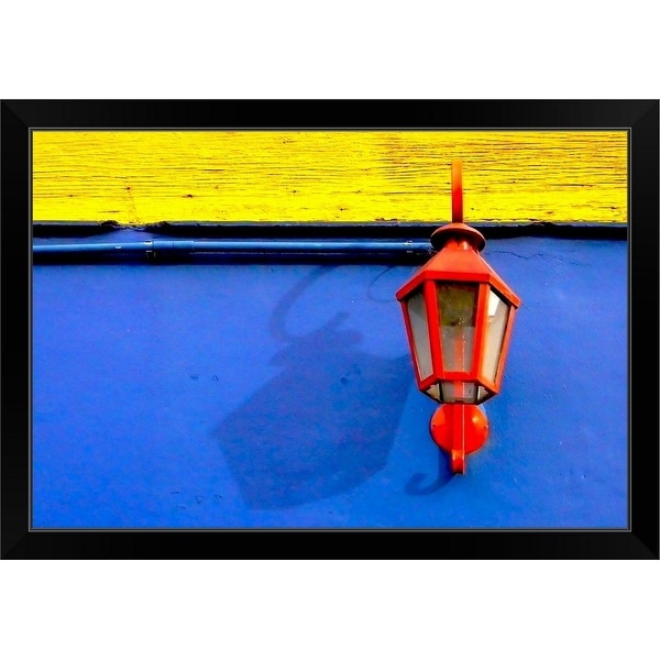 "A red streetlamp on a blue and yellow wall." Black Framed Print
