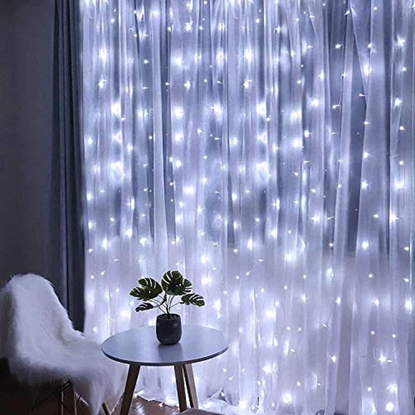 A Fairy Light wall curtain in a bedroom lit at night