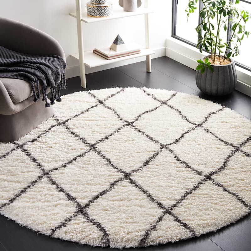 SAFAVIEH Handmade Flokati Agni Shag Solid Polyester Rug - 6'7" Round - Ivory/Dark Grey