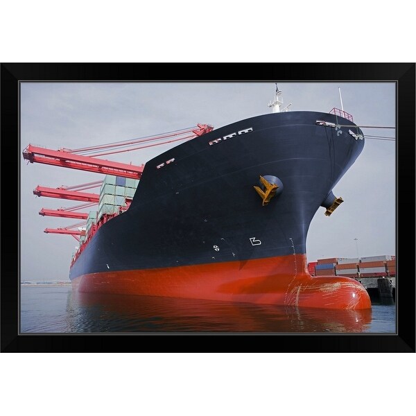 "Bow view of a cargo ship being loaded at port." Black Framed Print