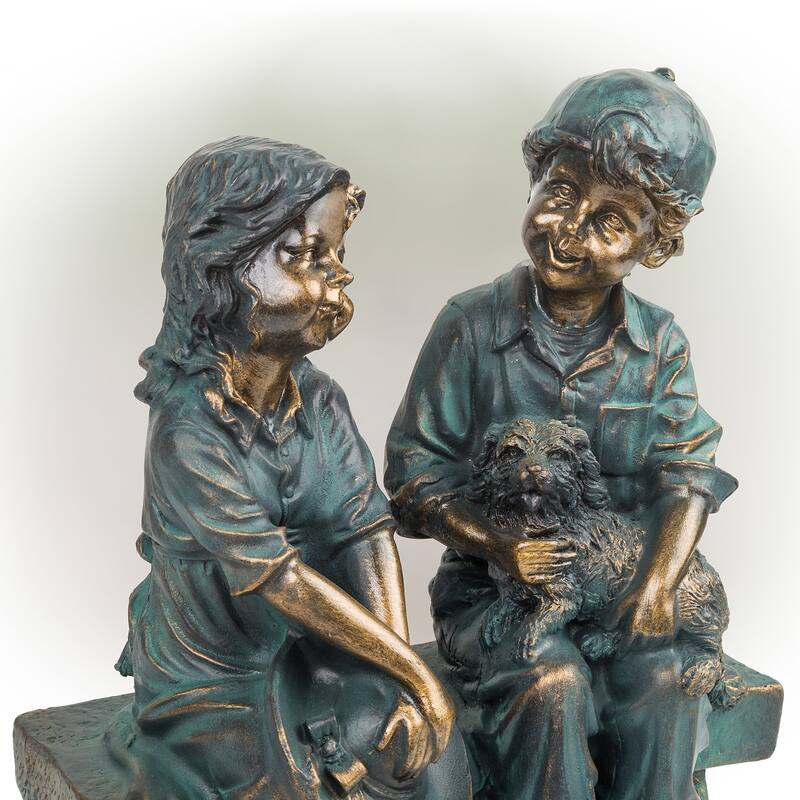 Girl and Boy Sitting on Bench with Puppy Statue