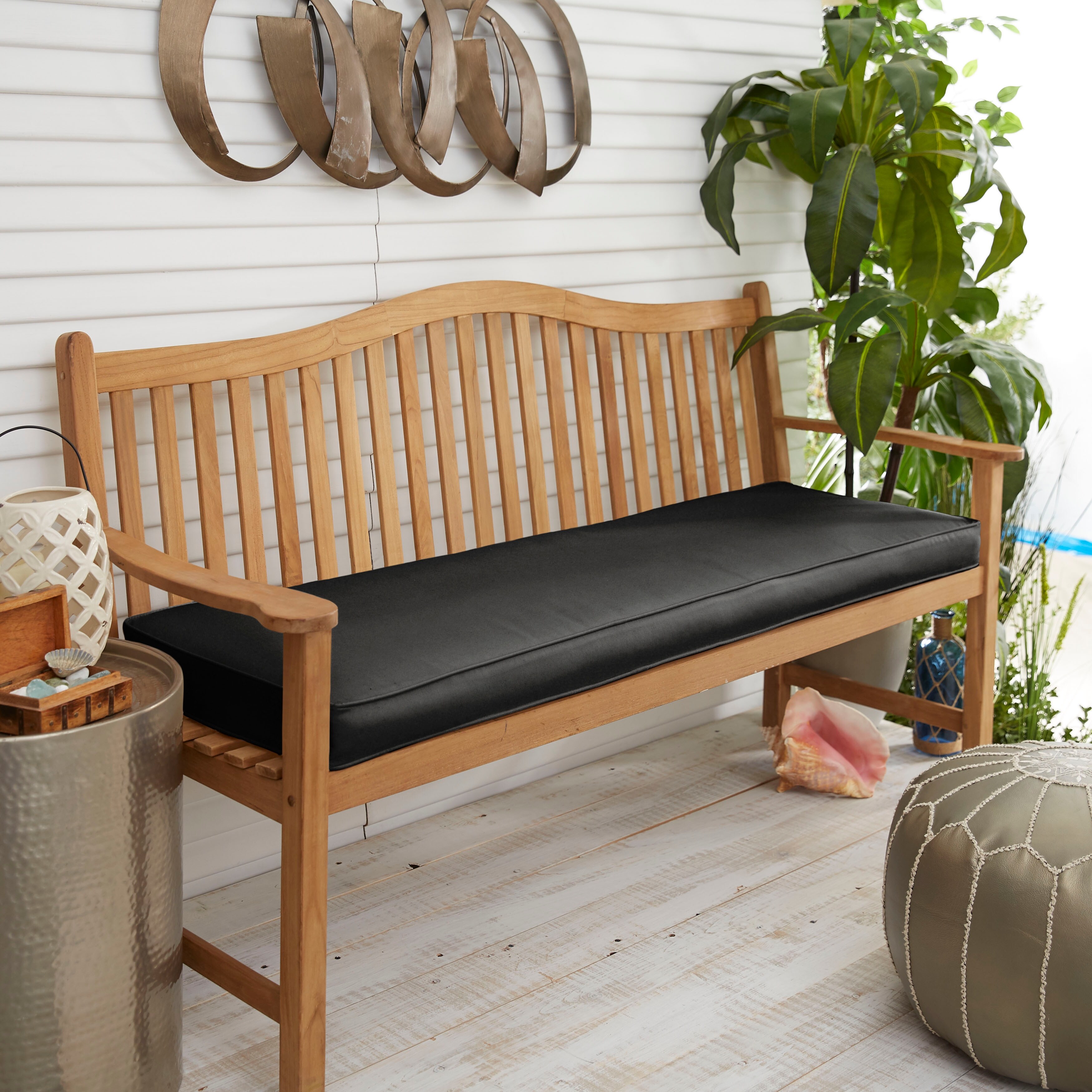 Black outdoor bench with store cushion