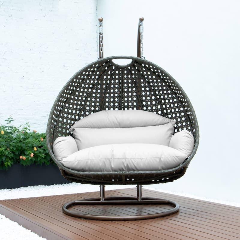 LeisureMod 2-Person Hanging Egg Swing Chair with Metal Stand - Handcrafted Beige Wicker, Patio Hammock Lounger with Cushions