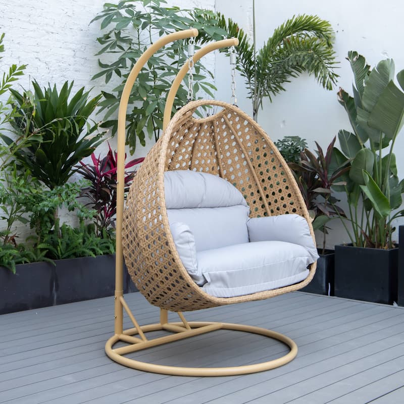 LeisureMod Mendoza 2-Person Hanging Egg Swing Chair - Handcrafted Light Brown Wicker, Patio Hammock Lounger with Cushions - 53"
