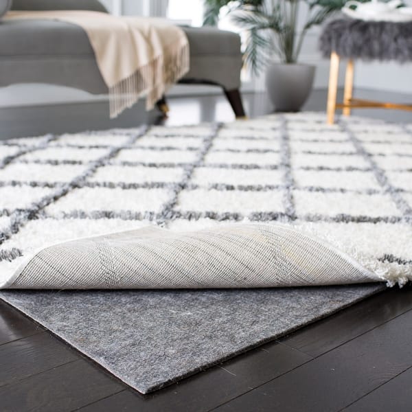https://ak1.ostkcdn.com/images/products/is/images/direct/ea9af3f88693cb1f07110067a185f6e02d0341fc/SAFAVIEH-Durable-Hard-Surface-and-Carpet-Non-Slip-Rug-Pad.jpg?impolicy=medium