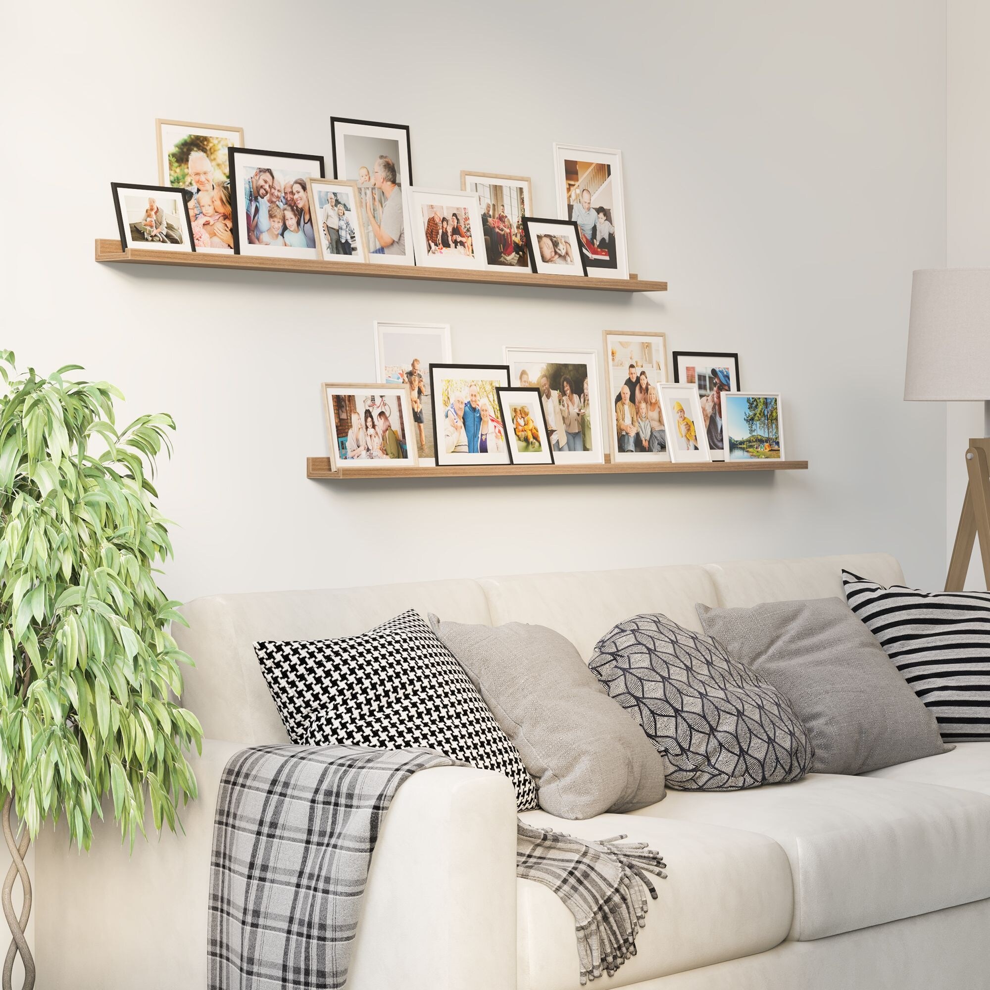Wooden picture ledges displayed on a living room wall above a sofa.