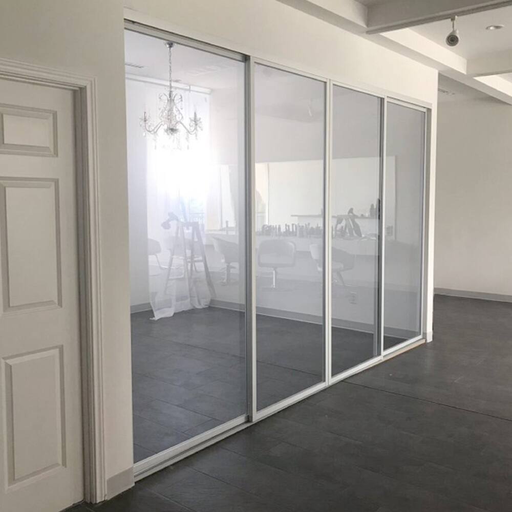 THE SLIDING DOOR COMPANY 4 Panel, sliding room divider, Clear Glass and Aluminum Frame on double track.