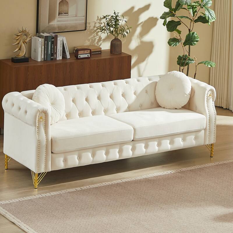 Chesterfield Sofa with Two Round Pillows, Featuring Copper Stud Detailing and Tufted Button Accents