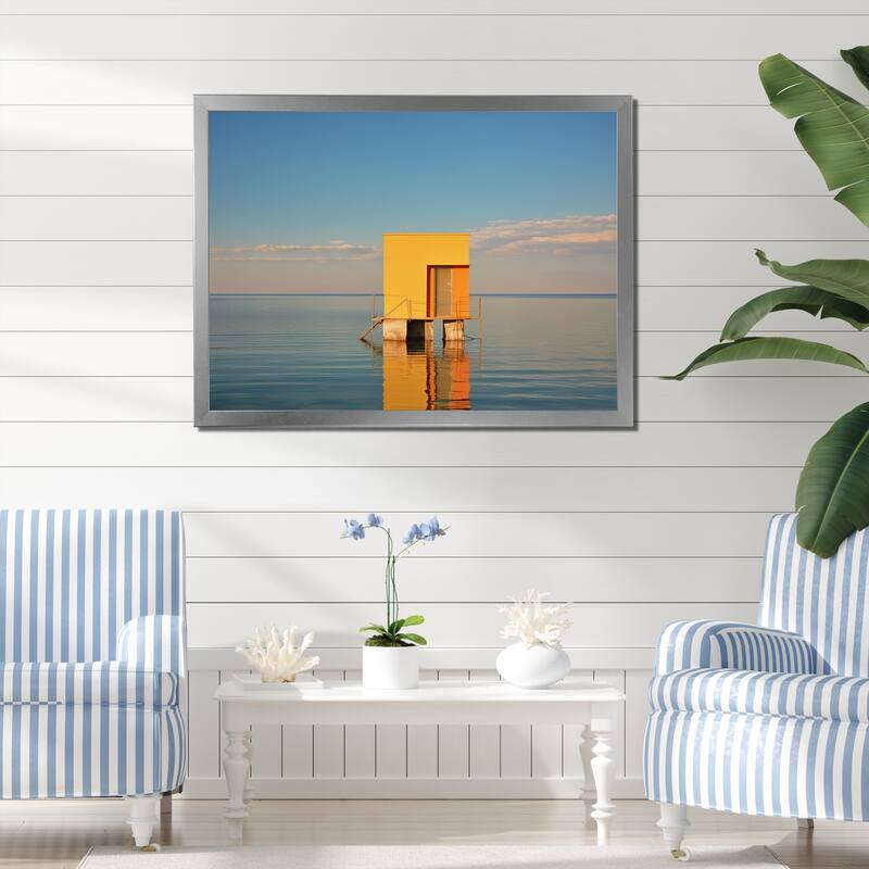 Designart "Coastal Minimalism Yellow Building In The Water I" Beach Framed Canvas Prints - 44 in. wide x 34 in. high - Silver