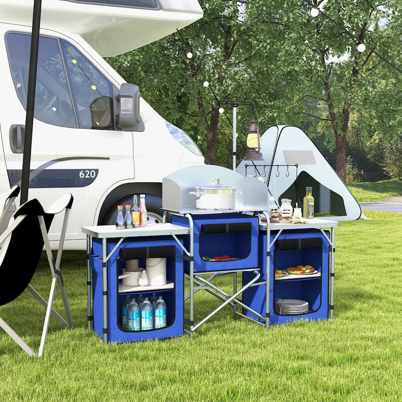 Outsunny Camping Kitchen Table, Portable Folding Camp Kitchen, Aluminum Cook Station with 3 Fabric Cupboards, Windshield - Blue