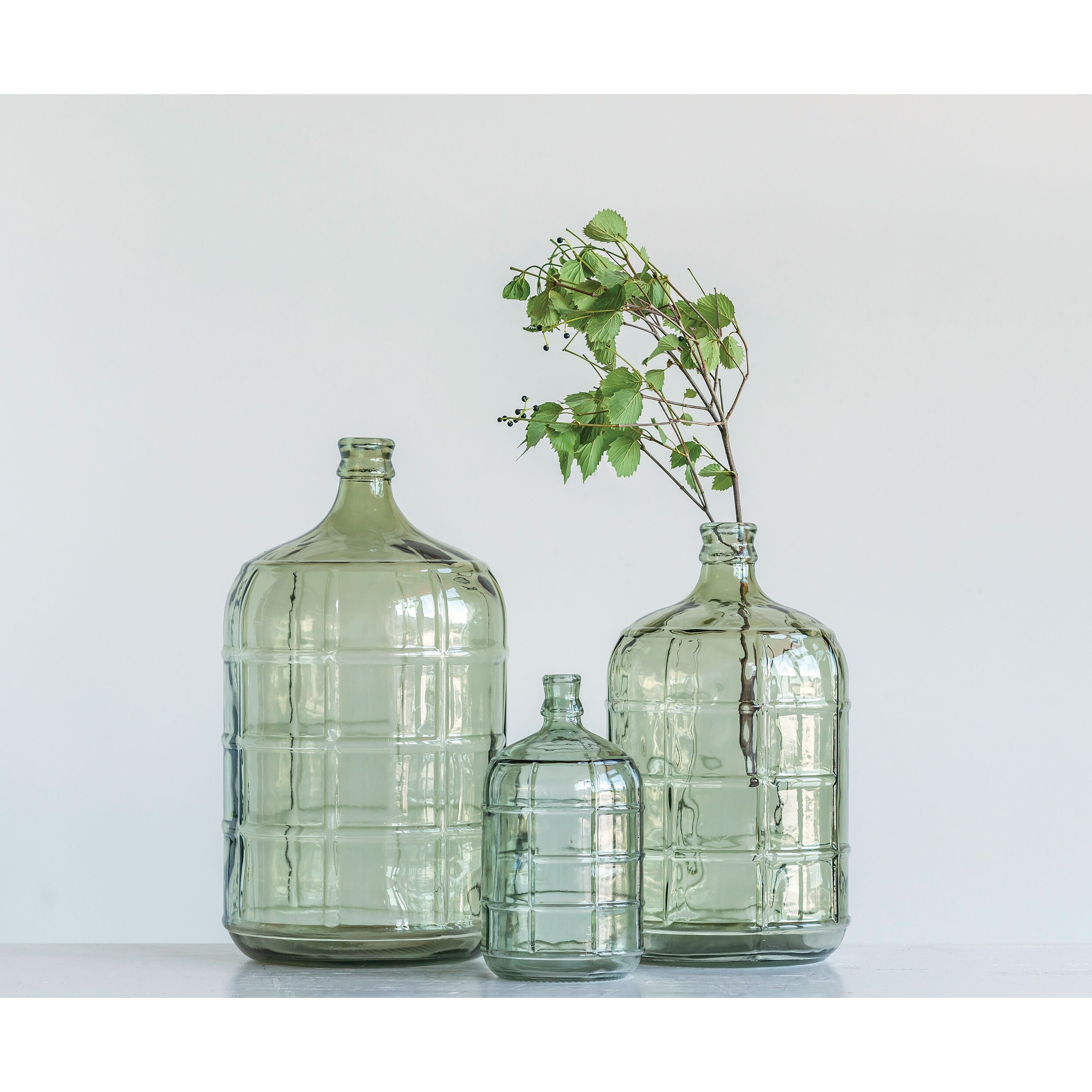 https://ak1.ostkcdn.com/images/products/is/images/direct/f2495b7ab92ed9b02cafa5c05b3283b4b904c67c/Large-Transparent-Green-Vintage-Reproduction-Glass-Bottle-with-Embossed-Windowpane-Design.jpg