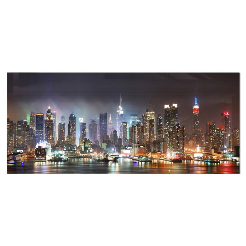 Designart 'Lit NYC Manhattan Skyline' Cityscape Photo Metal Wall Art - 28 in. wide x 12 in. high - 1 panel