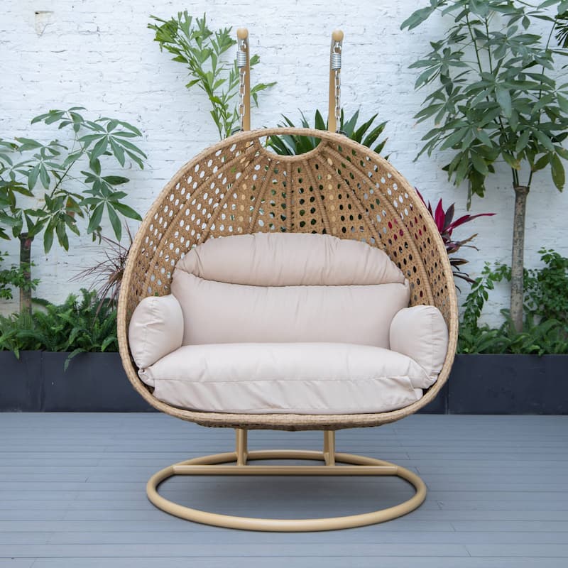 LeisureMod Mendoza 2-Person Hanging Egg Swing Chair - Handcrafted Light Brown Wicker, Patio Hammock Lounger with Cushions - 53"