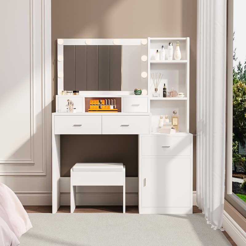 The vanity with a mirror is equipped with a hair dryer rack