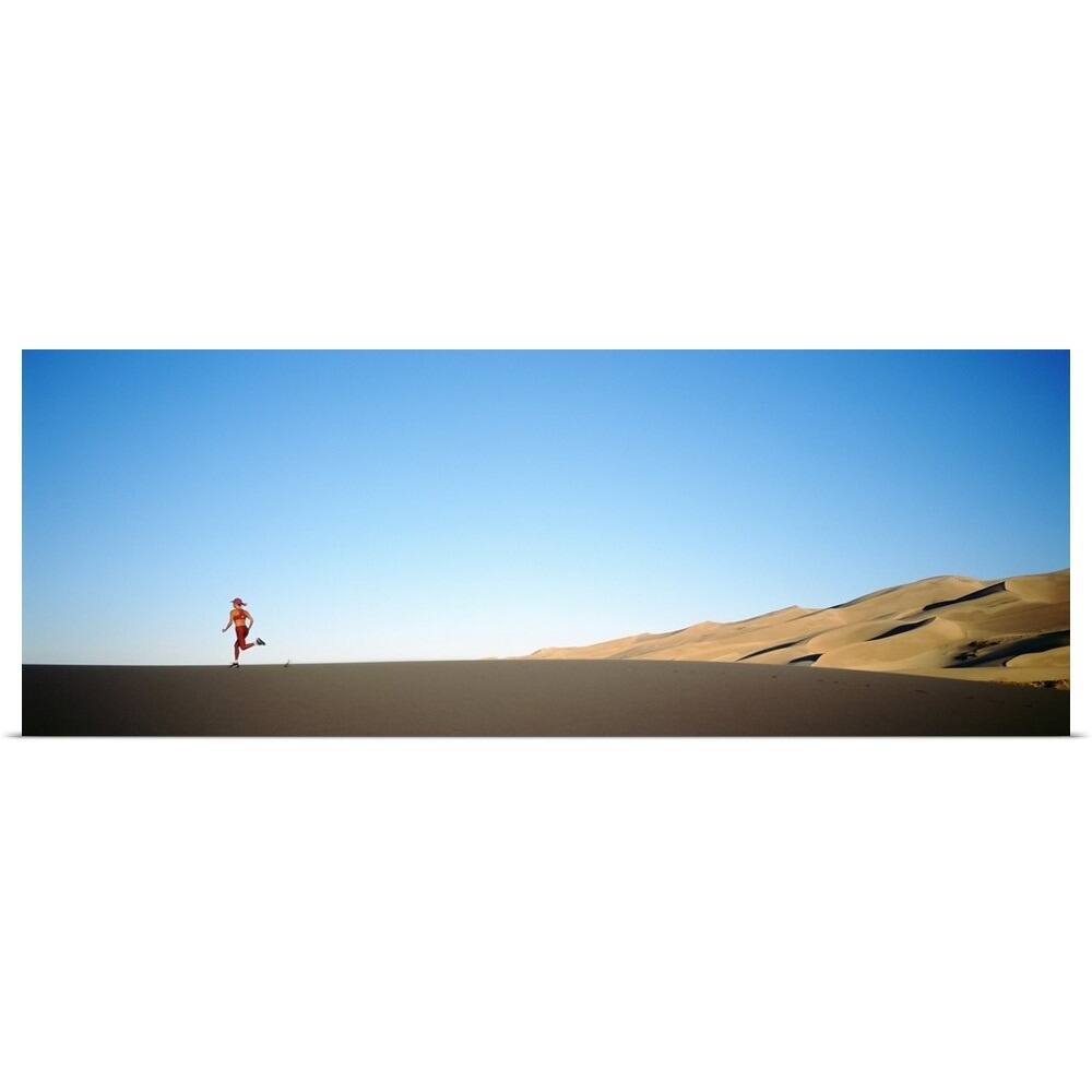 Rear view of a woman running in the desert, Great Sand Dunes National Monument, Colorado - Multi