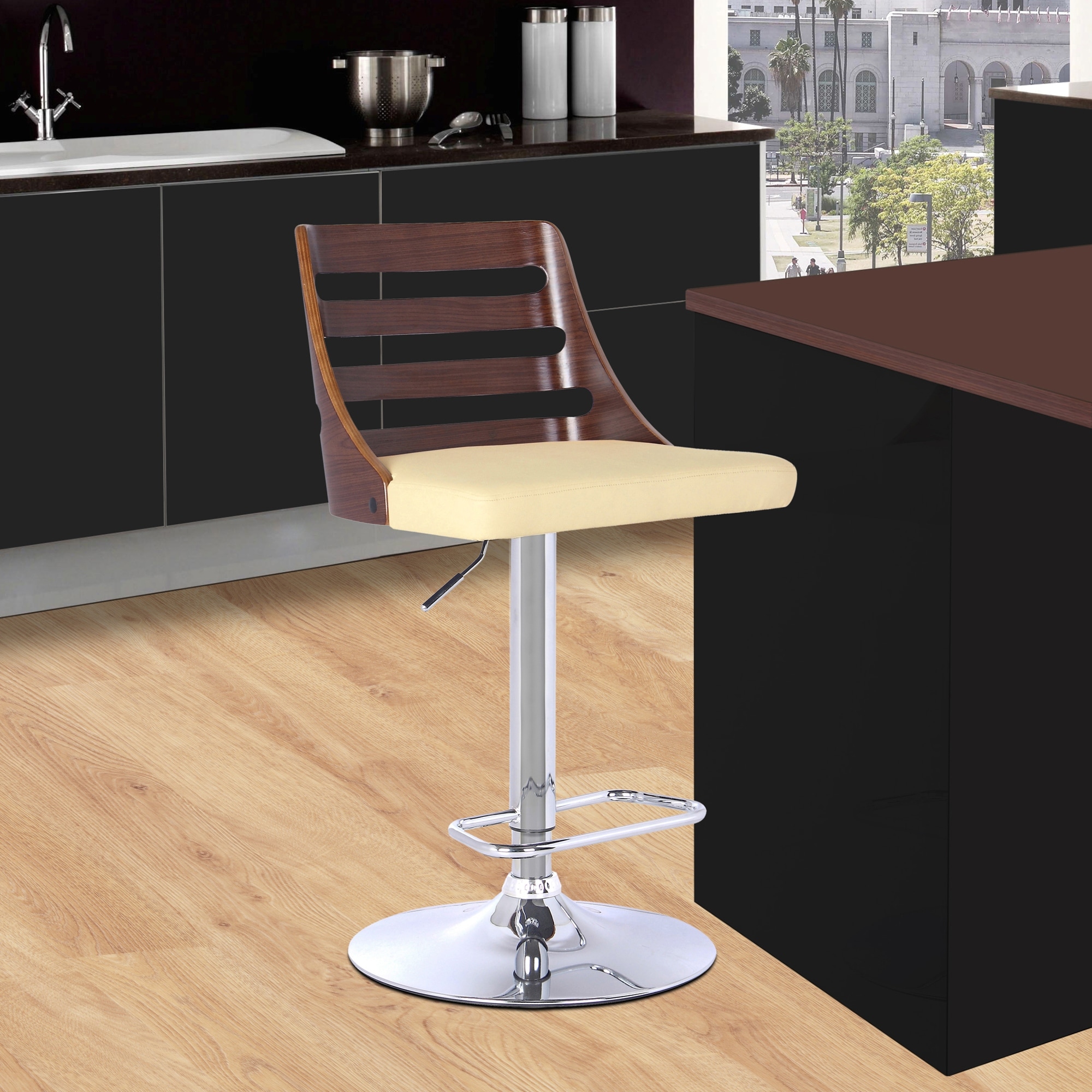 Bar stool with wooden backrest, cream cushioned seat, chrome pedestal base, and a black cabinet/tower behind—image shows kitchen setting.