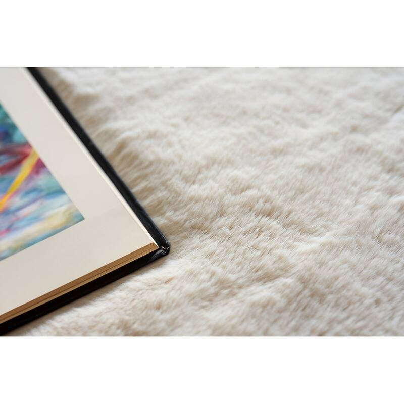 EXQUISITE RUGS Hand-stitched Polyacrylic Beige Area Rug.