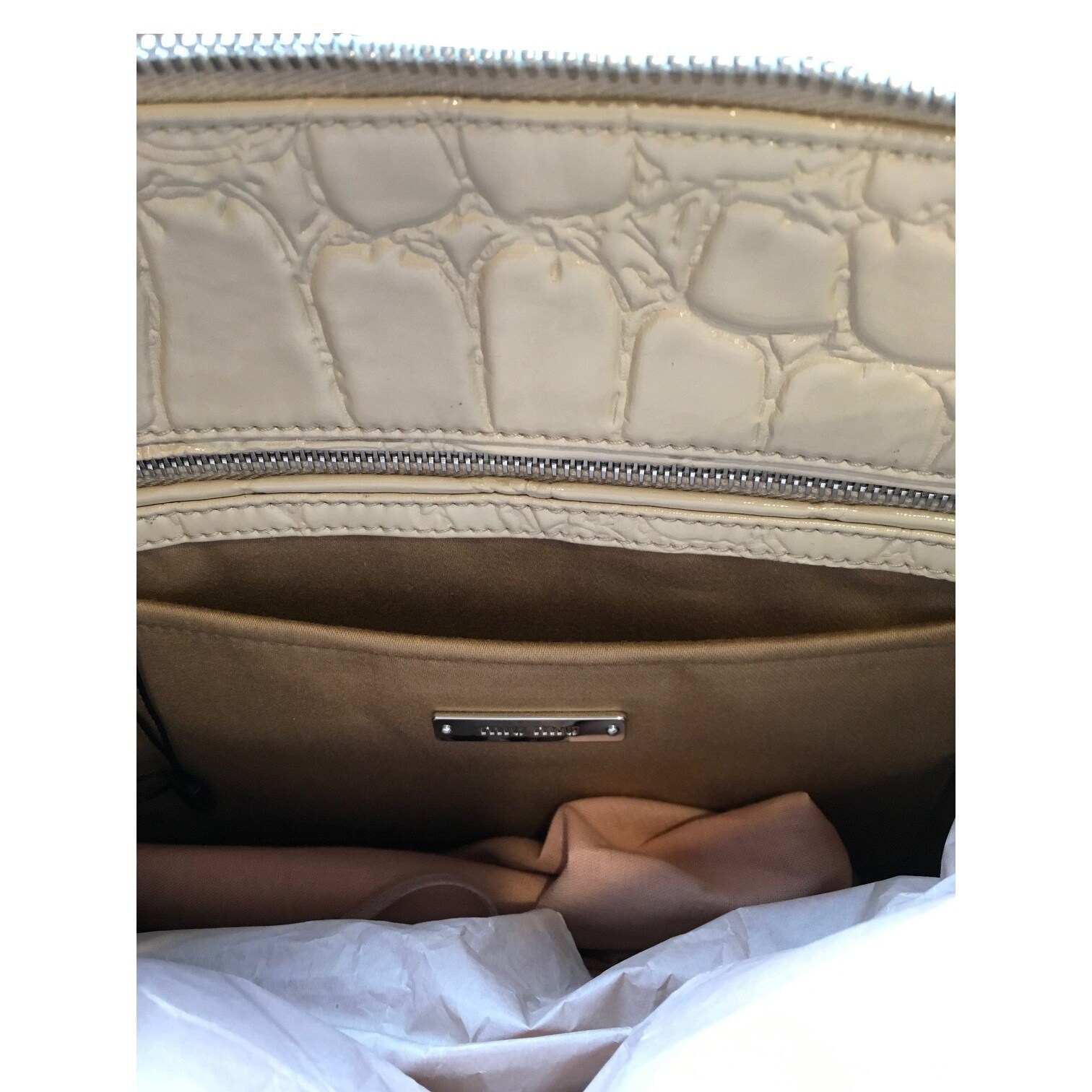 beige patent clutch bag