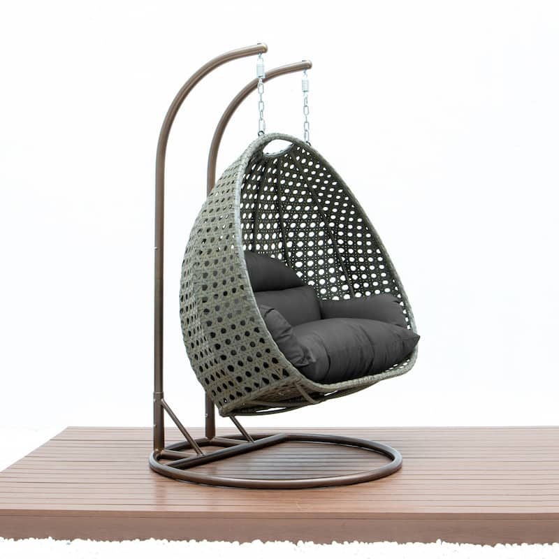 LeisureMod 2-Person Hanging Egg Swing Chair with Metal Stand - Handcrafted Beige Wicker, Patio Hammock Lounger with Cushions
